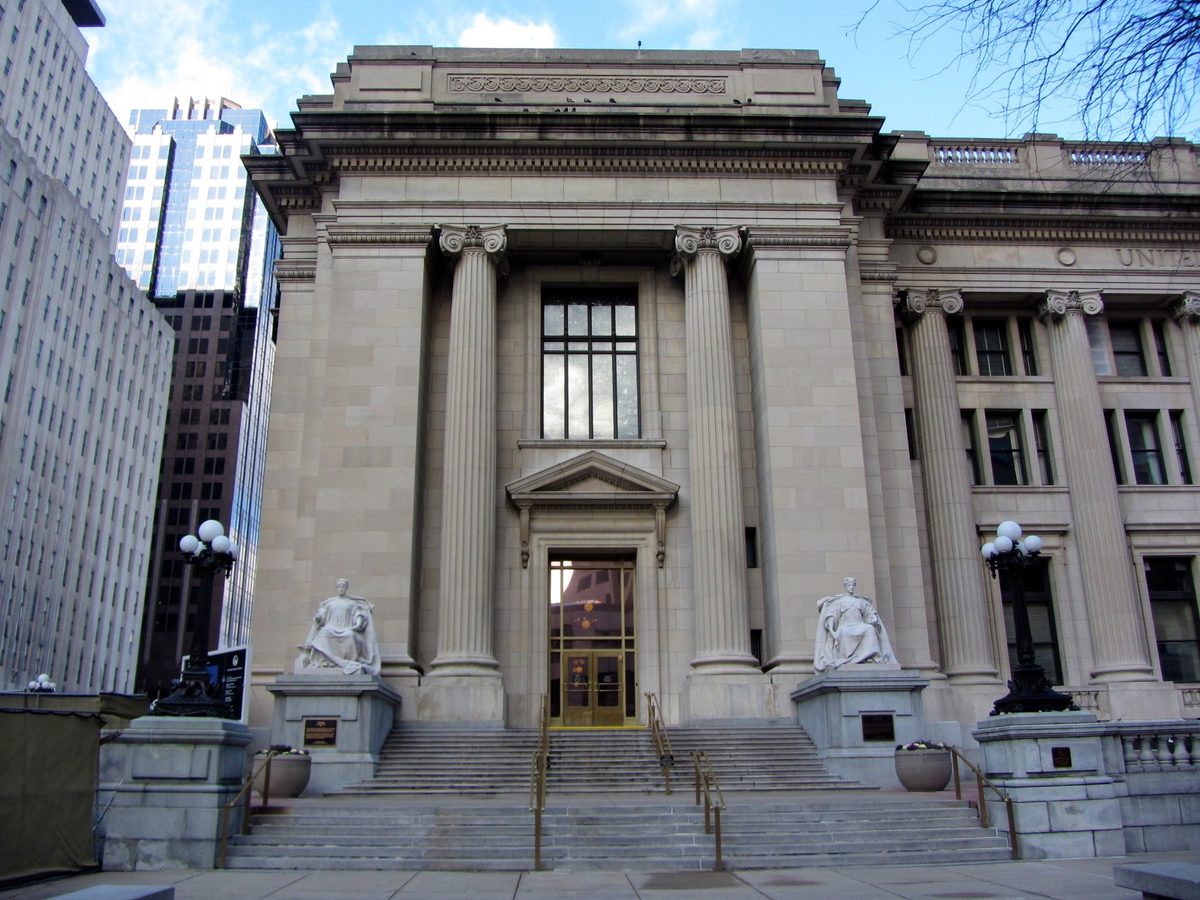 Federal courthouse exterior illustrating I-220B order of supervision review and first-month compliance planning