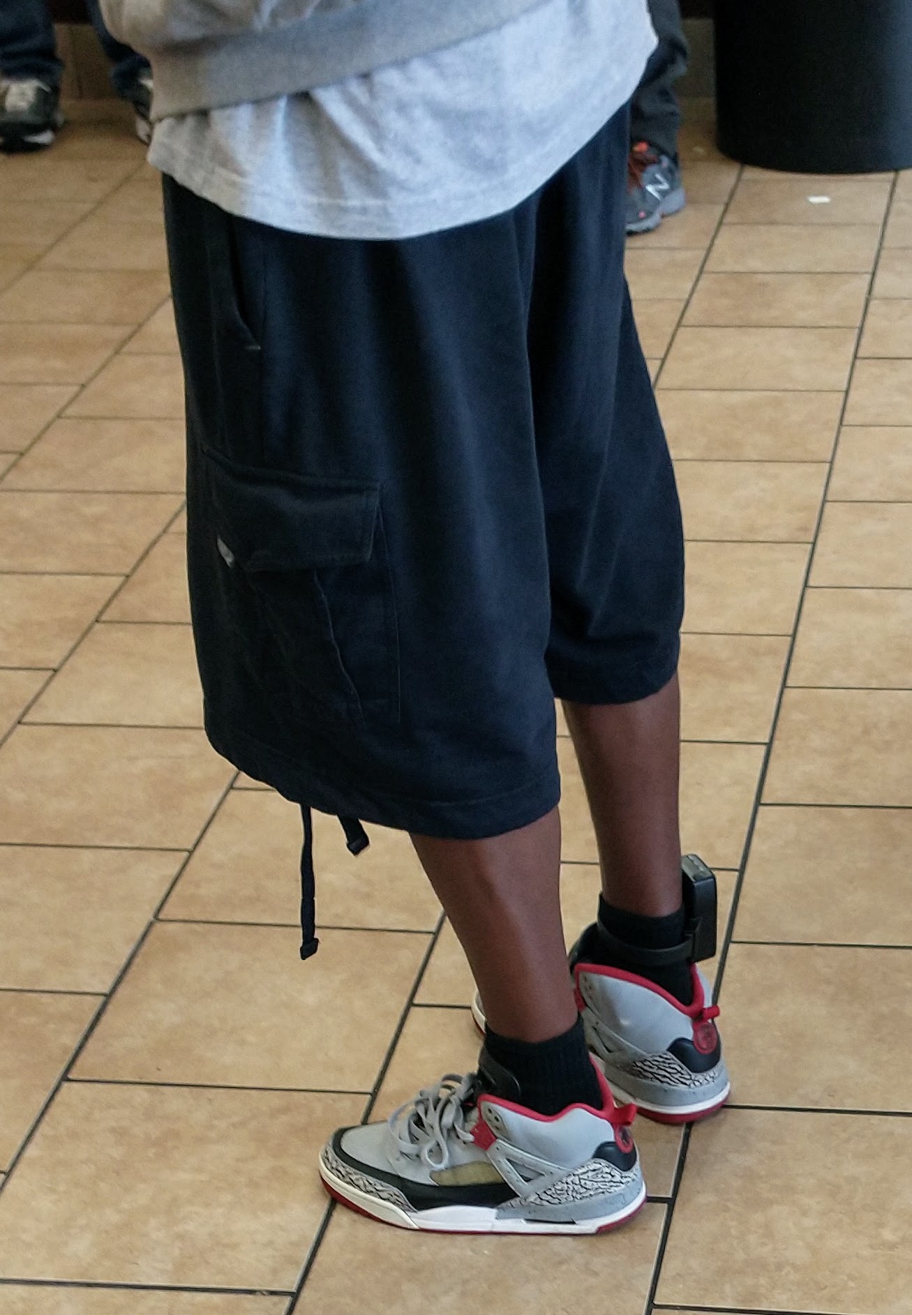 Electronic tagging device illustrating practical compliance under ICE ankle monitor rules