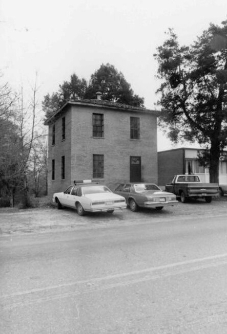 Historic parish jail exterior illustrating long-standing jail hold practices and custody transfers