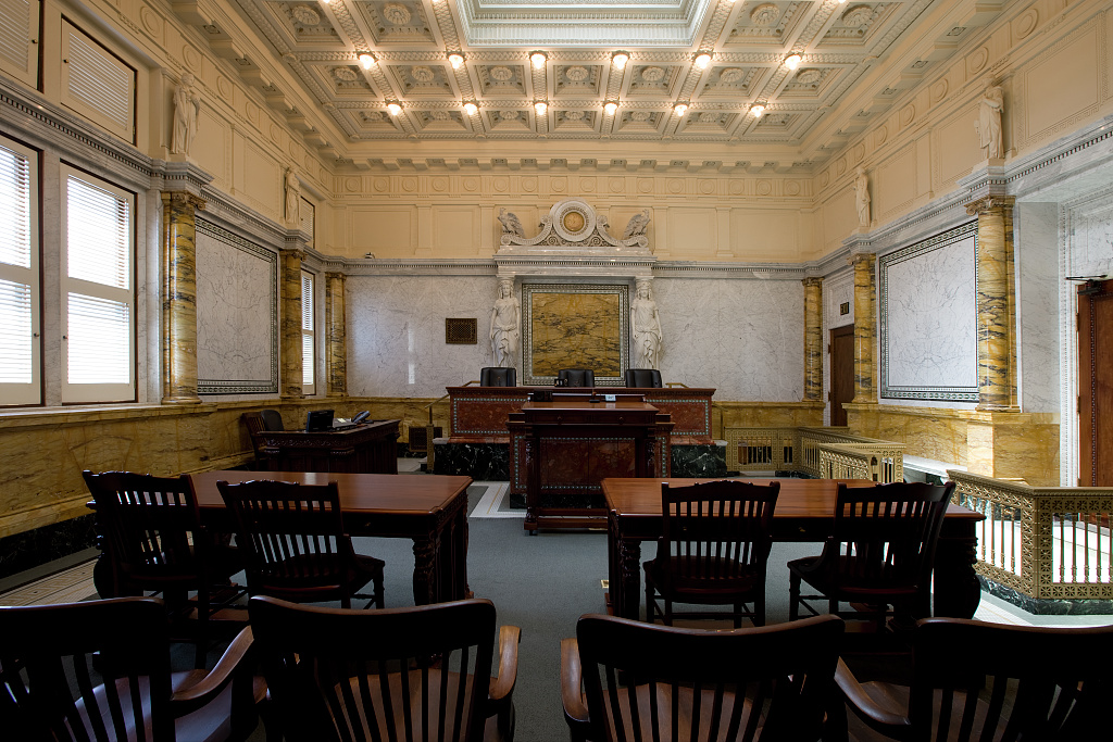 Master calendar hearing in immigration court guide with courtroom interior showing first-hearing note-taking and deadline tracking