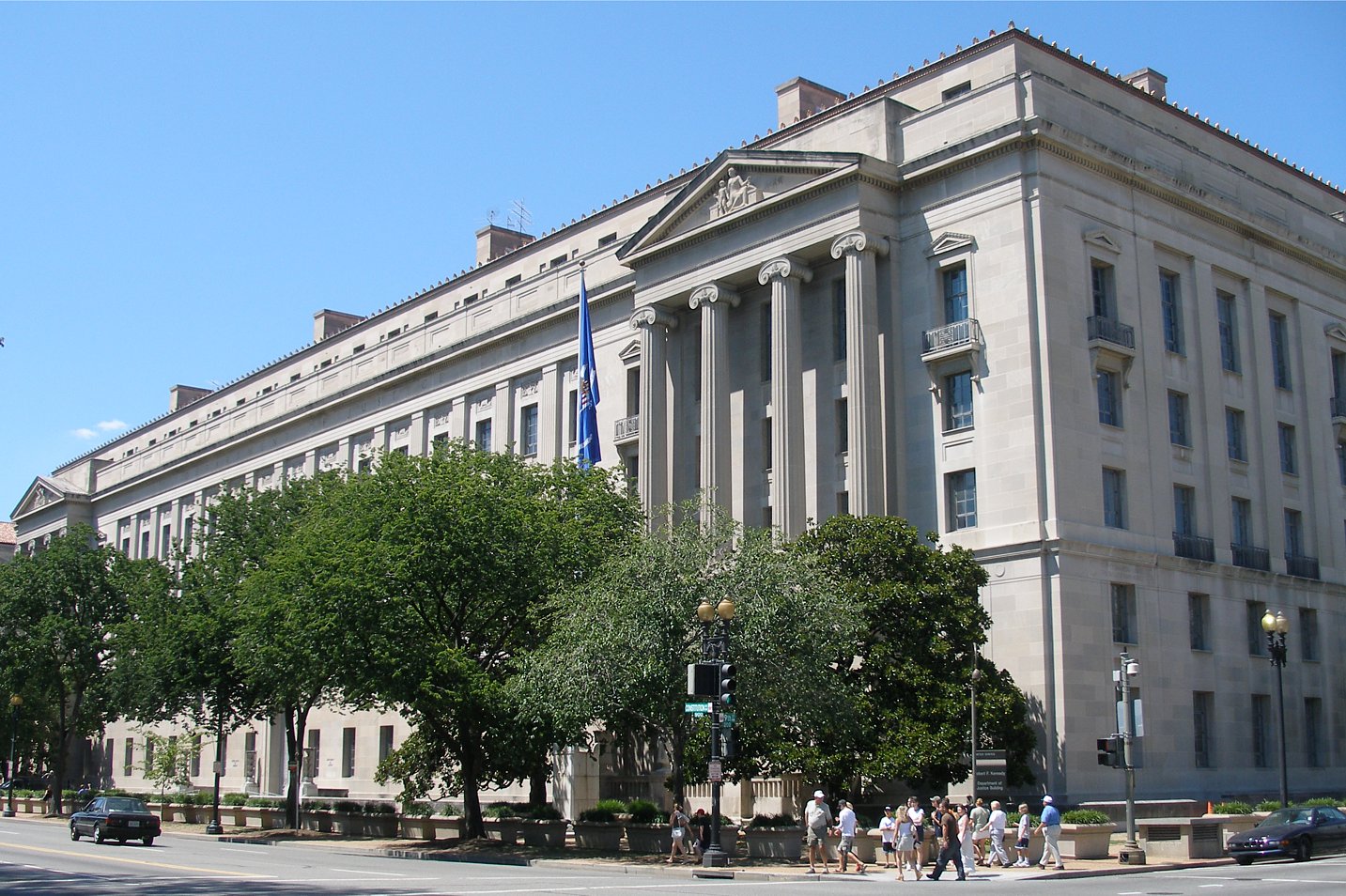Motion to reopen in absentia guide illustrated with the U.S. Department of Justice headquarters in Washington