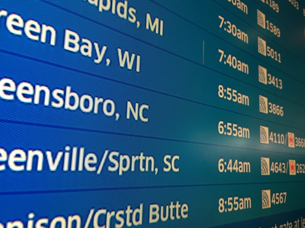 Airport departure board illustrating voluntary departure immigration court deadlines and travel planning